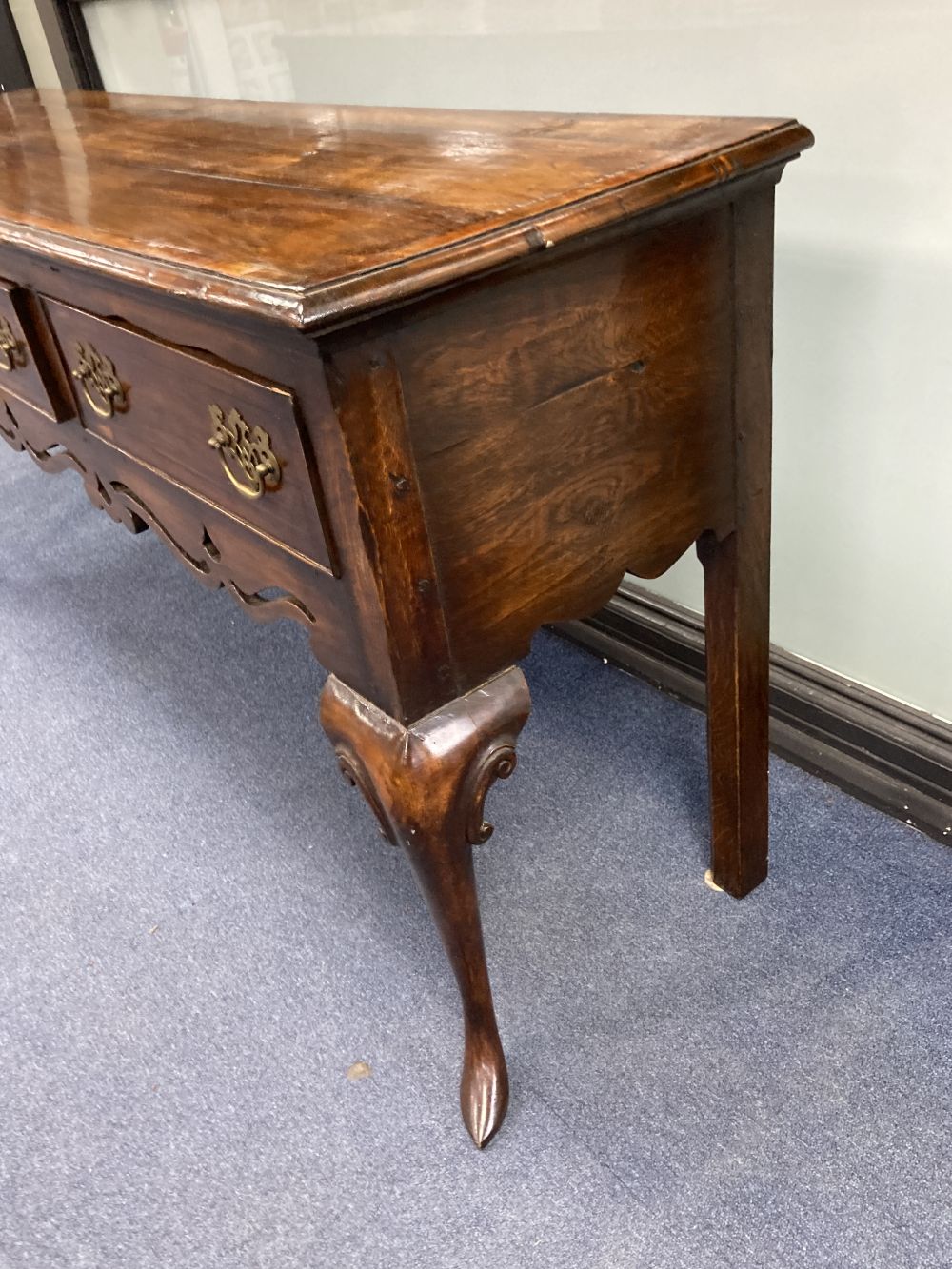 A mid 18th century style oak and mahogany crossbanded dresser, fitted three small drawers, raised on cabriole legs
